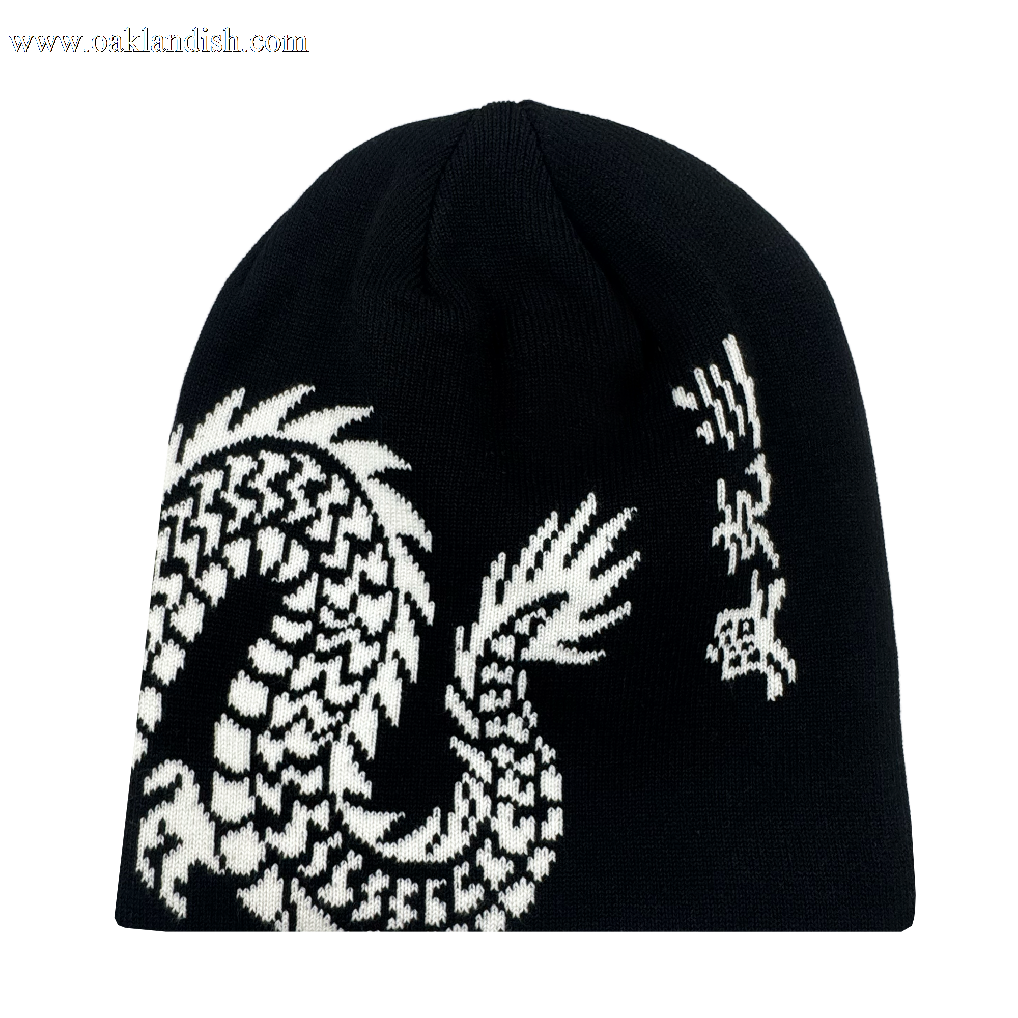 The ORSC Dragon Skully by Oakland Roots SC is a black knit beanie with a white, pixelated dragon graphic wrapping around one side, featuring its head and claw at the top right and its scaled body along the bottom.
