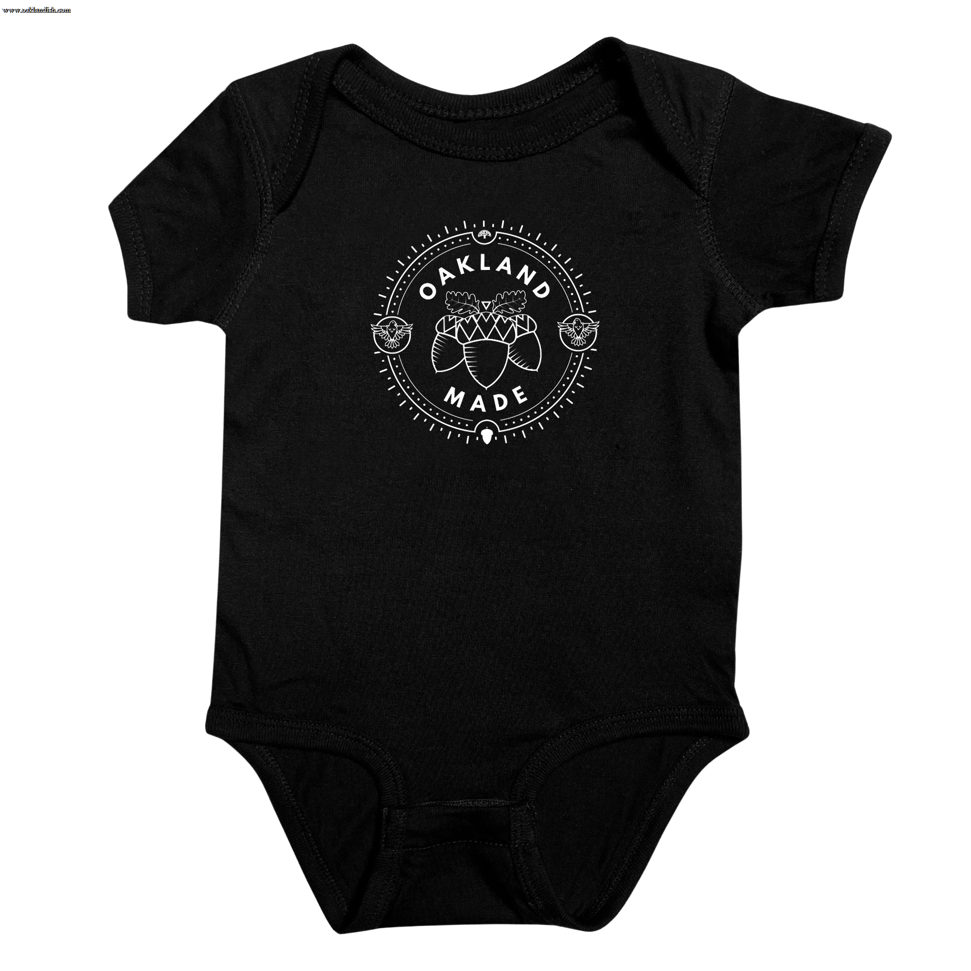 Black infant one-piece with a white circle graphic with the words “Oakland Made” and hand-drawn chestnuts.