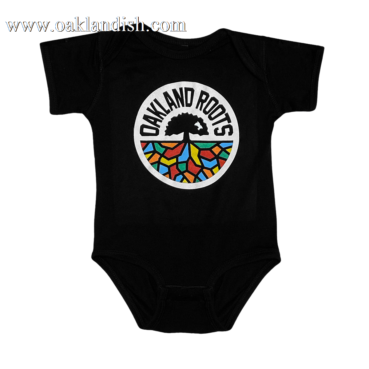 A black Infant Oakland Roots SC Logo One-Piece from Oakland Roots SC, showcasing the club's emblem. This emblem has a white circular background with "OAKLAND ROOTS" in bold, black, capitalized text curved at the top. Inside the circle is a striking black tree, its roots intricately colored in blue, red, yellow, green, and orange—celebrating this vibrant sports club.