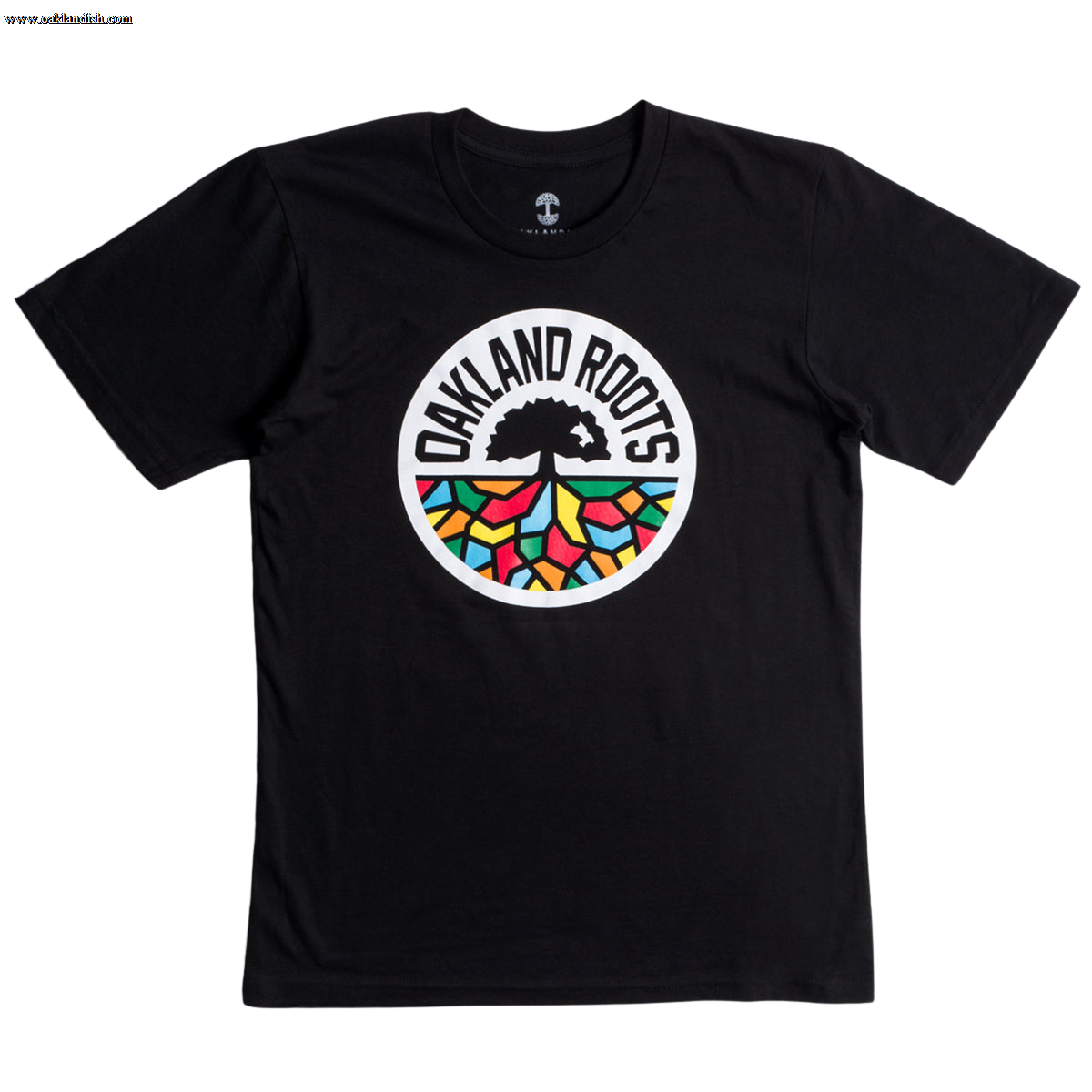 The Oakland Roots SC Classic Tee by Oakland Roots SC is a black t-shirt featuring a circular logo in the center. The logo displays a black tree encircled by the text "OAKLAND ROOTS" in white. Beneath the tree's roots, you'll find colorful geometric shapes in red, green, yellow, and blue, symbolizing the social good values of Oakland Roots Sports Club.