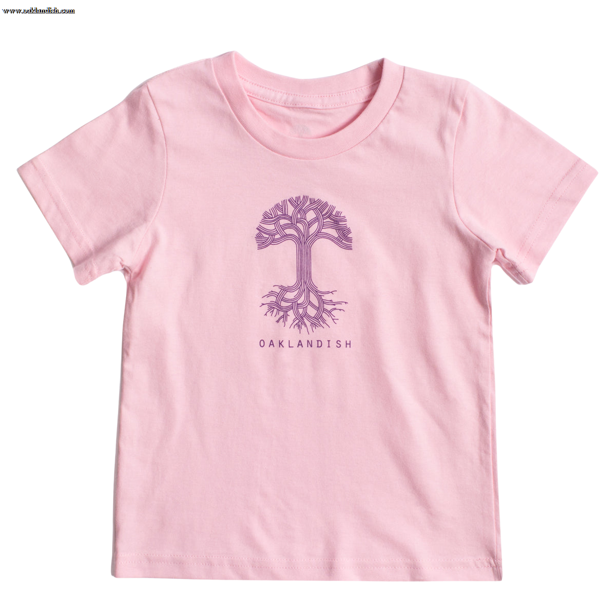 A light pink, 100% cotton Toddler Oaklandish Classic Logo Tee from Oaklandish featuring a purple tree graphic with intricate branches and roots in the center. Below the tree, "OAKLANDISH" is printed in a simple, all-caps font. The t-shirt is laid flat against a white background.