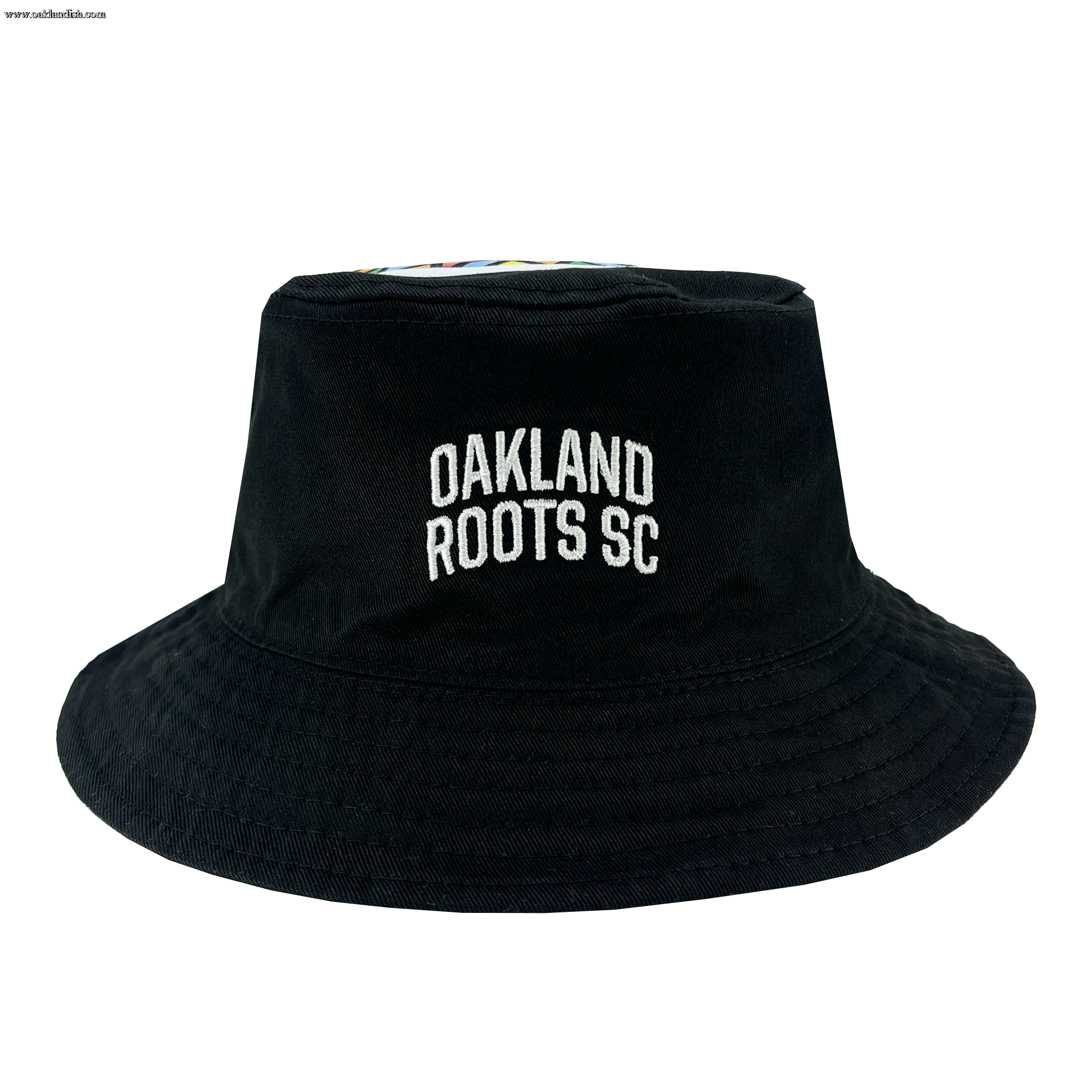 A black reversible bucket hat named the "Oakland Soul & Roots SC Reversible Bucket" by Oakland Roots SC, featuring "OAKLAND ROOTS SC" embroidered in white on the front. The hat has a classic brim and appears to be made of a fabric material, with a smooth, slightly structured crown. The background is white, highlighting the hat's details.
