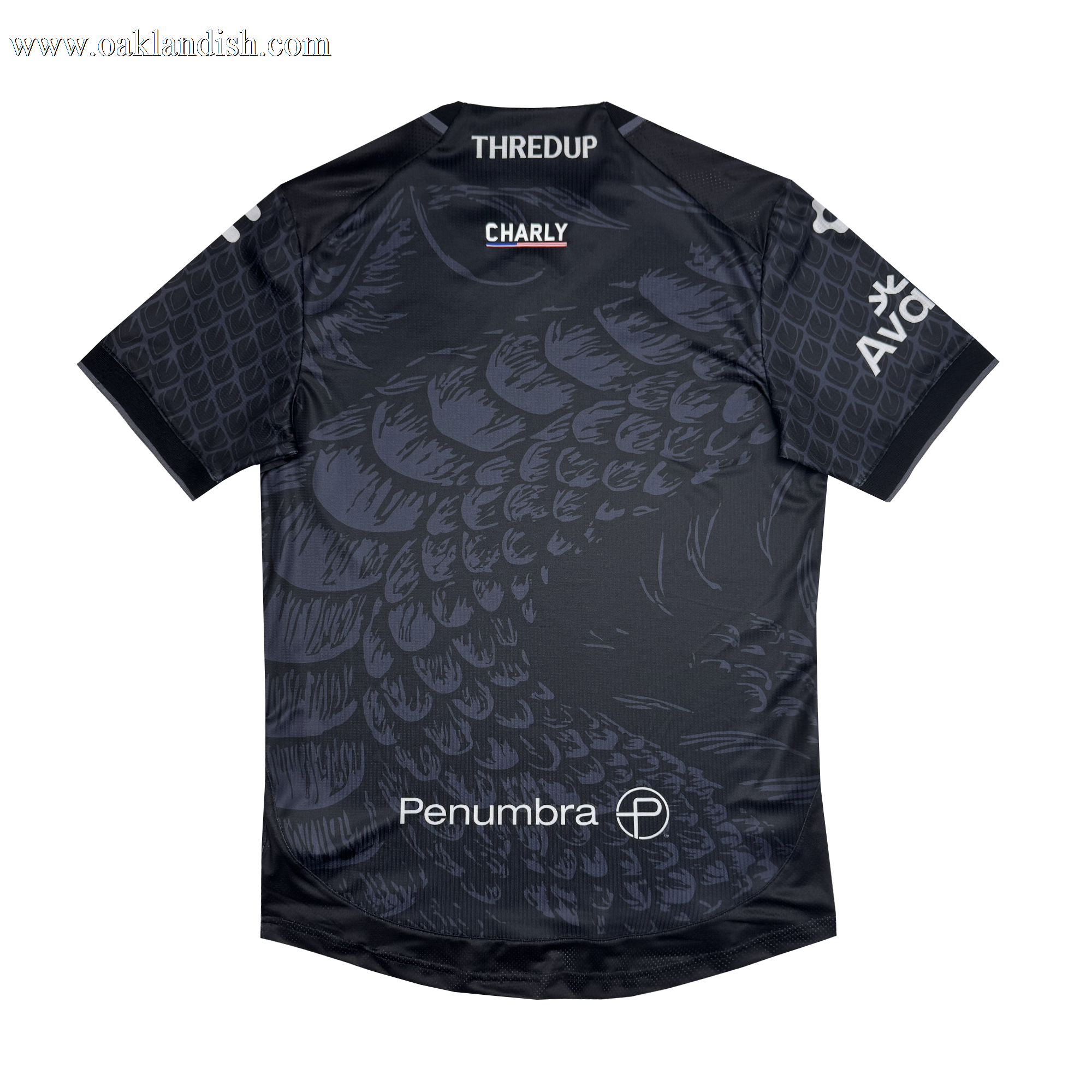 The Unisex Oak-ness Awakens Kit by Oakland Roots SC is a dark gray soccer jersey featuring a subtle scaled pattern inspired by the Oak-ness Monster, with bold white "Penumbra," "THREDUP," "CHARLY," and "AVOF" logos on the chest, shoulders, and front.