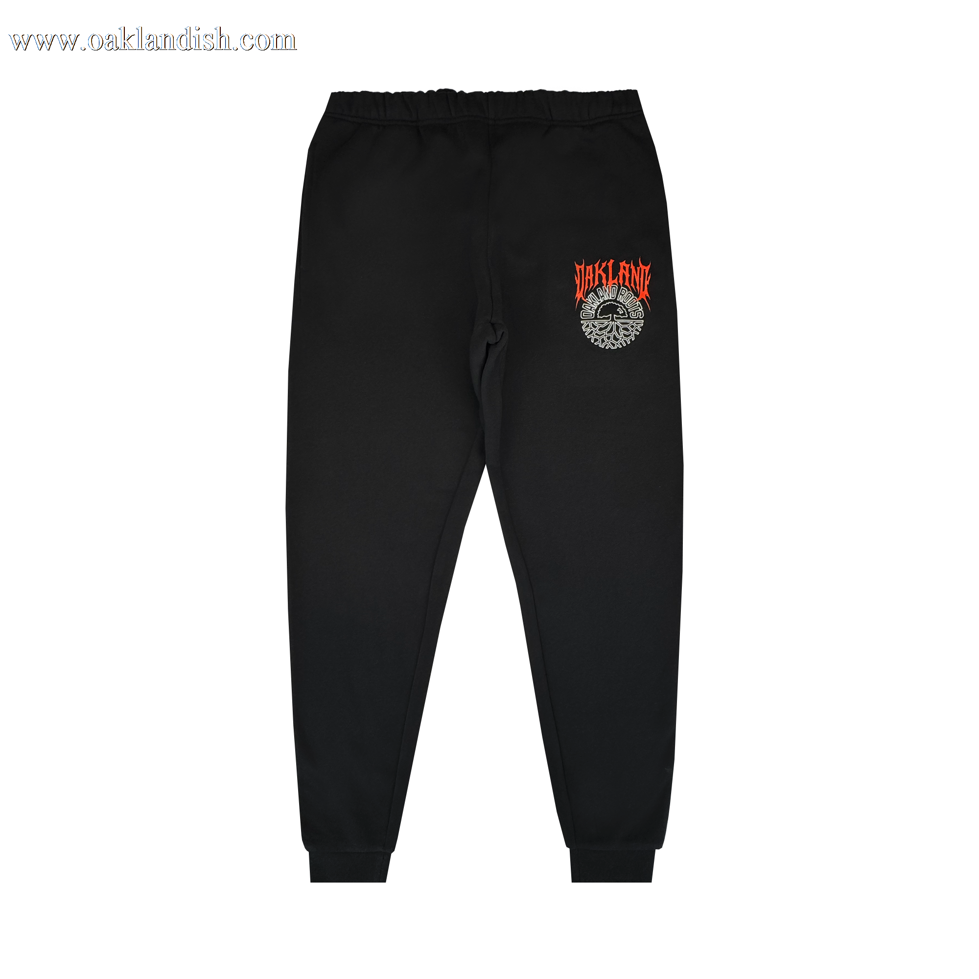 The Oakland Roots SC Forge Pant is a black men's sweatpant with elastic waistband and cuffs. Features red and orange "STAFF FIRE" text above a white graphic on the left thigh. Plain white background. From Oakland Roots SC.