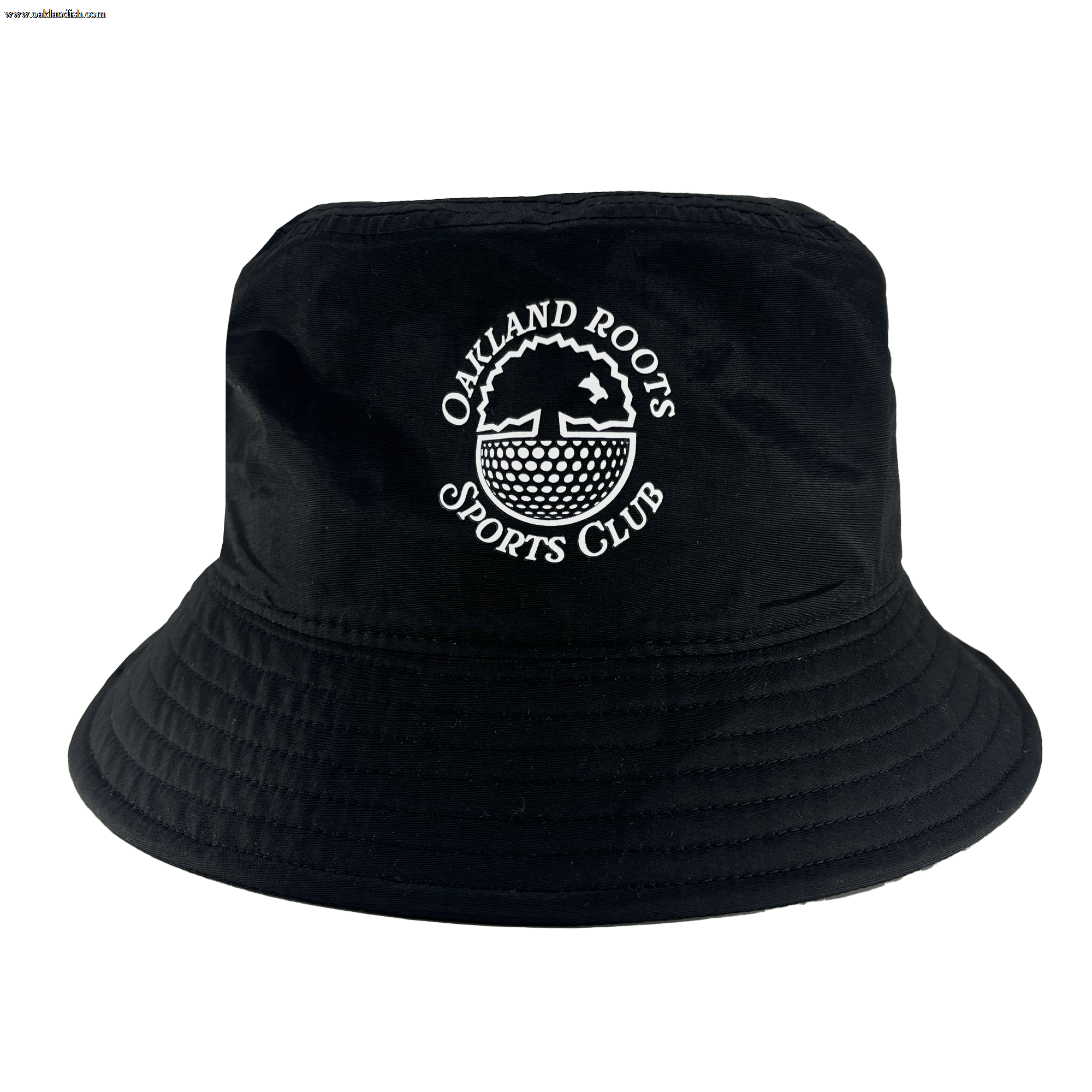 The Heritage Bucket Hat by Oakland Roots SC is a black bucket hat featuring white embroidered text and logo on the front. The text reads "OAKLAND ROOTS SPORTS CLUB," encircling a stylized tree and roots design in a circular emblem. Designed to promote social good, the hat includes a downward-sloping brim with visible stitching along the top and brim.