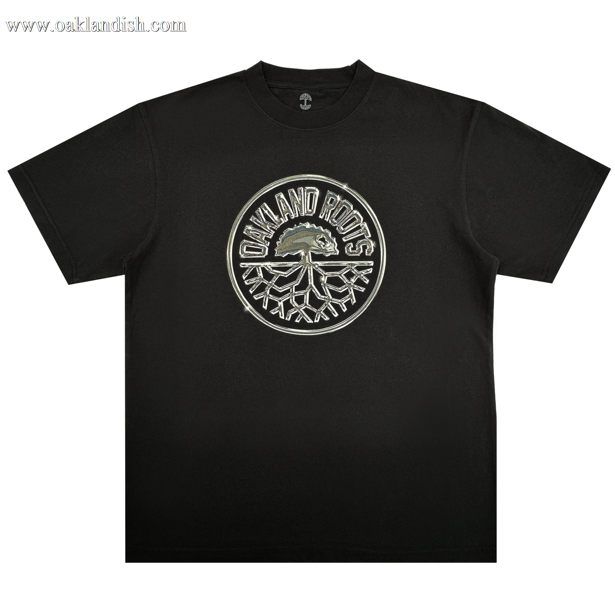 The Platinum Crest Tee by Oakland Roots SC is a black classic-fit t-shirt with a bold circular "OAKLAND ROOTS" logo in white and gray, featuring the iconic tree crest—perfect for any Oakland Roots SC fan.
