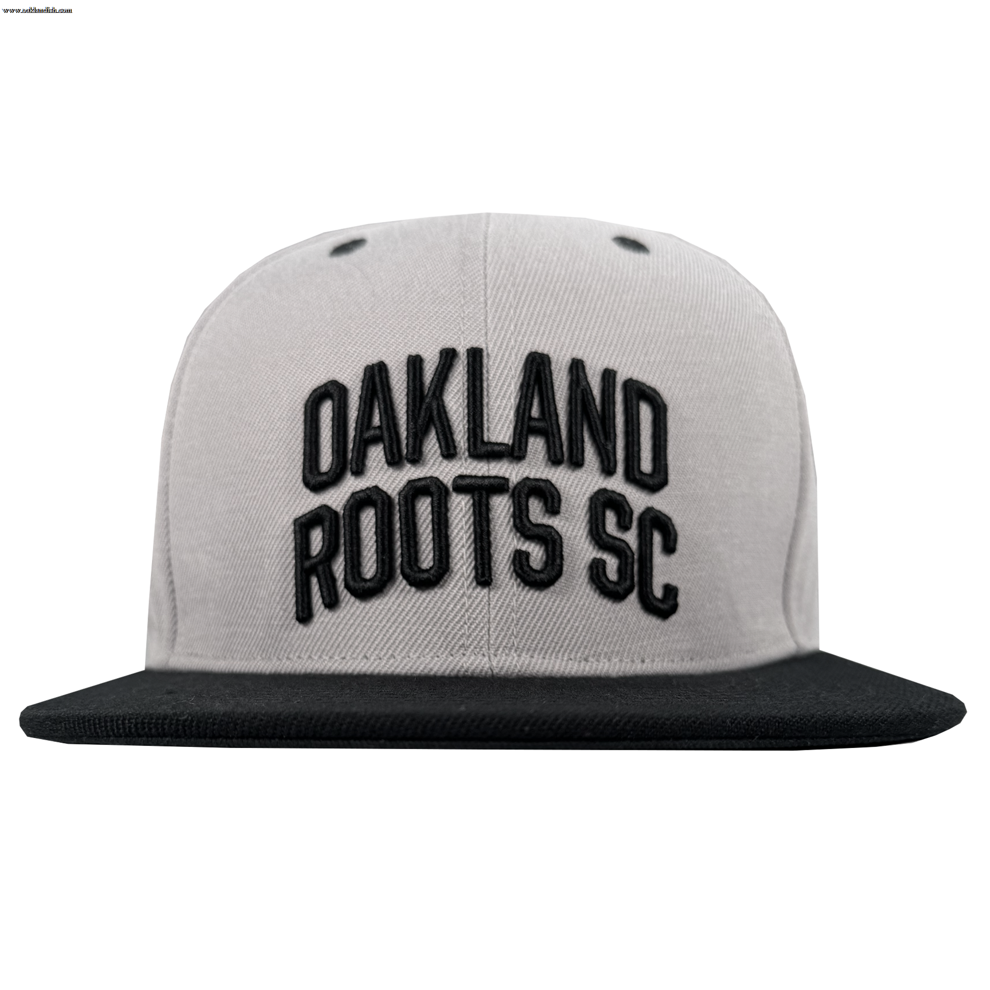 The Oakland Roots SC Arch Text Snapback by Oakland Roots SC features a gray crown, black brim, and bold black "OAKLAND ROOTS SC" embroidery on the front. Photographed head-on against a white background.