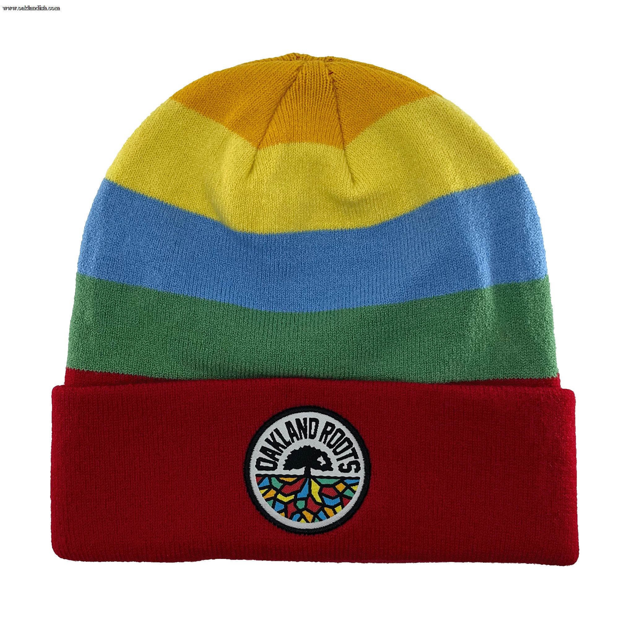 The Oakland Roots SC Mosaic Stripe Beanie features horizontal stripes in yellow, blue, and green, along with a red fold-over cuff. The cuff proudly displays a circular patch with the text "OAKLAND ROOTS," a black tree logo, and rainbow-colored roots to show your support for the Oakland Roots Sports Club.