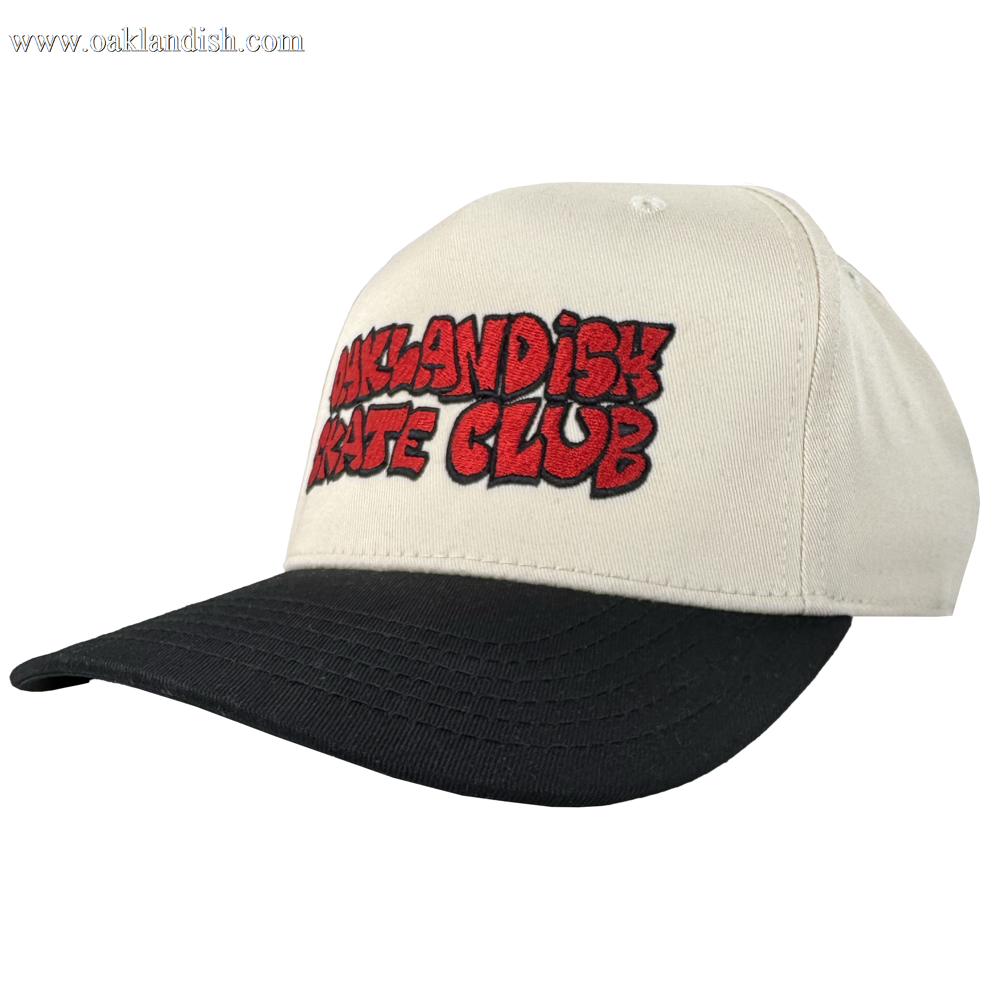 The Oaklandish Skate Club 2-Tone Hat by Oaklandish features a cream crown, black bill, and bold red graffiti-style "OAKLANDISH SKATE CLUB" embroidery outlined in black—an ideal piece for skate culture. Shown on a plain white background.