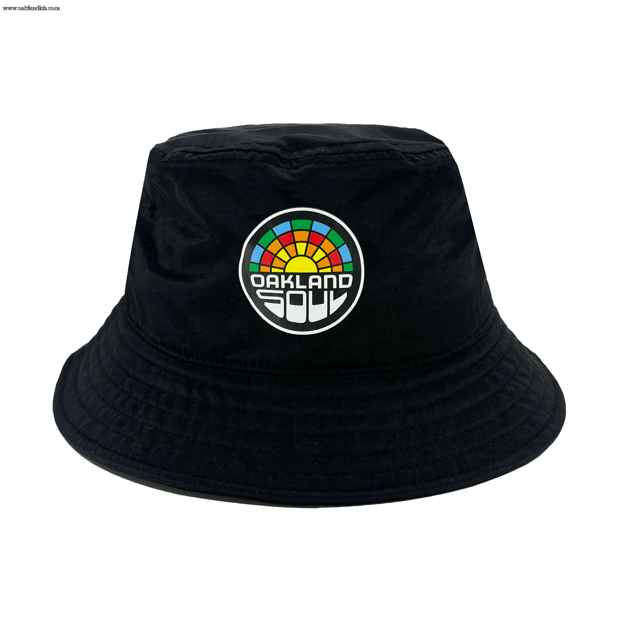 Check out the Oakland Soul Logo Bucket Hat, a stylish black bucket hat adorned with the Oakland Soul logo on the front. The vibrant, multi-colored semicircle evokes a rainbow, with "OAKLAND" displayed prominently in bold white letters and "SOUL" in smaller white letters beneath it. Show your support for this inspiring women's soccer team in the USL W-League!