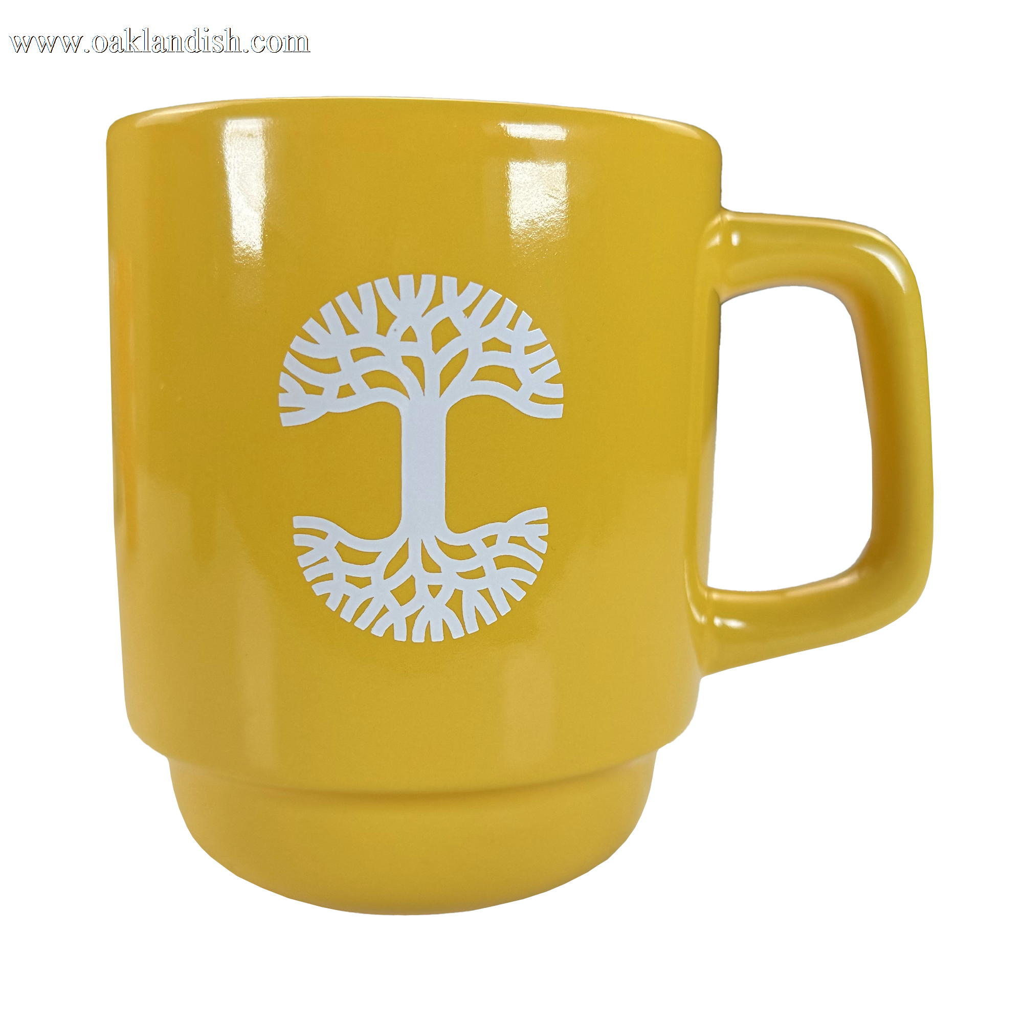 The Logo Stack Mug by Oaklandish is a yellow ceramic mug with a white stylized tree logo in the center, featuring circular branches and roots, a broad handle, and a glossy finish. Displayed on a plain white background.
