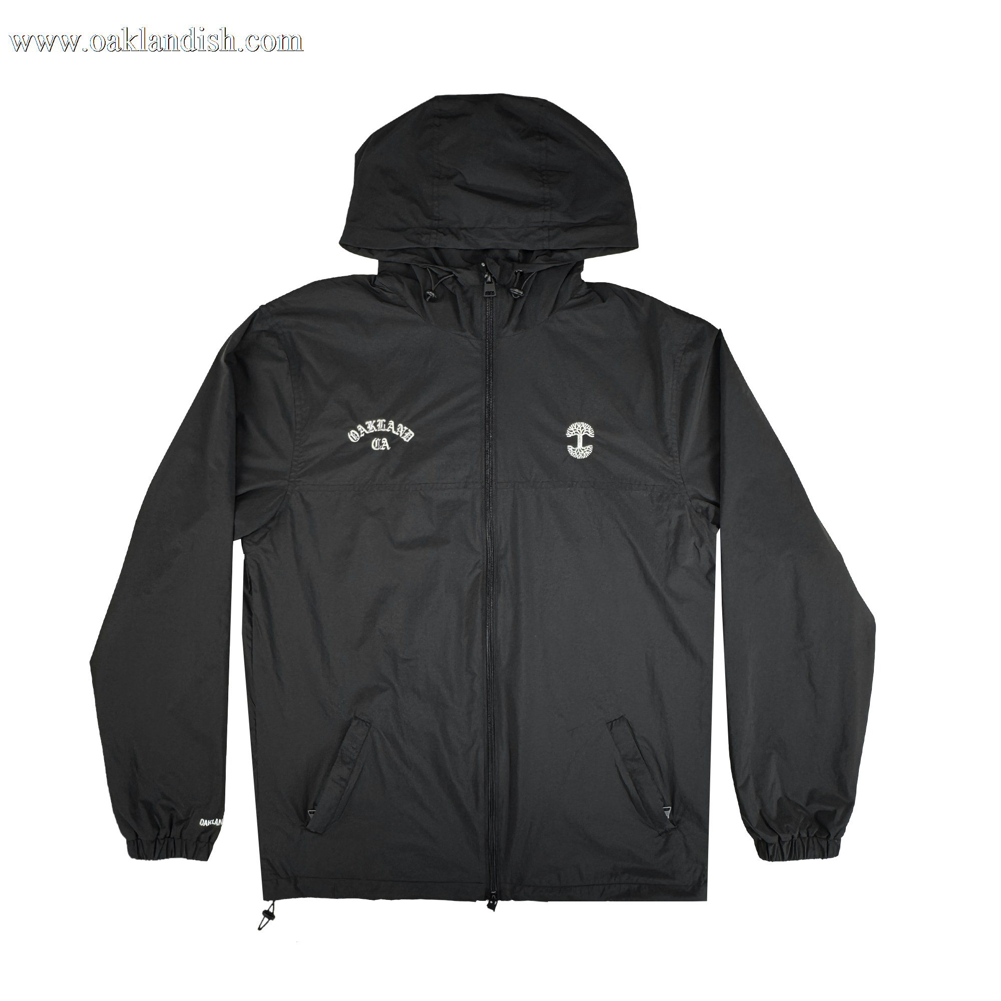 The Oaklandish Susurrus Track Top is a sleek black nylon hooded jacket with a front zipper, elastic cuffs, and two front pockets. "OAKLAND CA" is printed in white on the left chest; a small white circular logo accents the right chest.