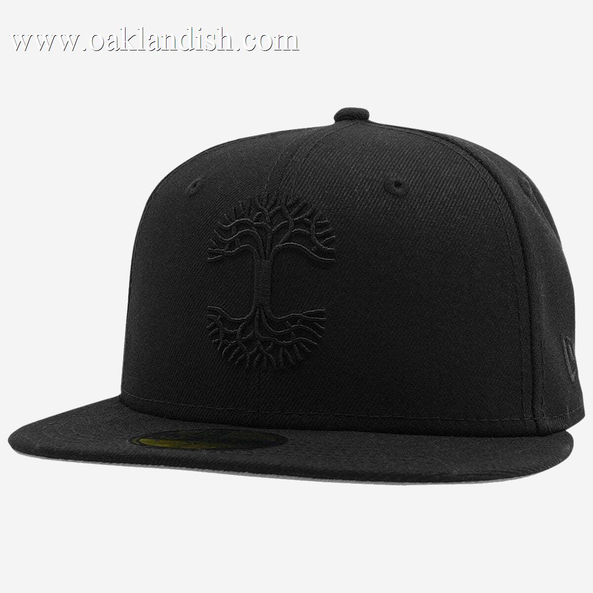 The New Era X Oaklandish Classic 59FIFTY Fitted Cap is a black hat featuring an embroidered tree emblem on the front. It boasts a flat brim and a high, fitted structured crown adorned with eyelets for ventilation. The centrally placed tree design, in matching black thread, exudes a subtle and sleek appearance representative of the Oaklandish logo.