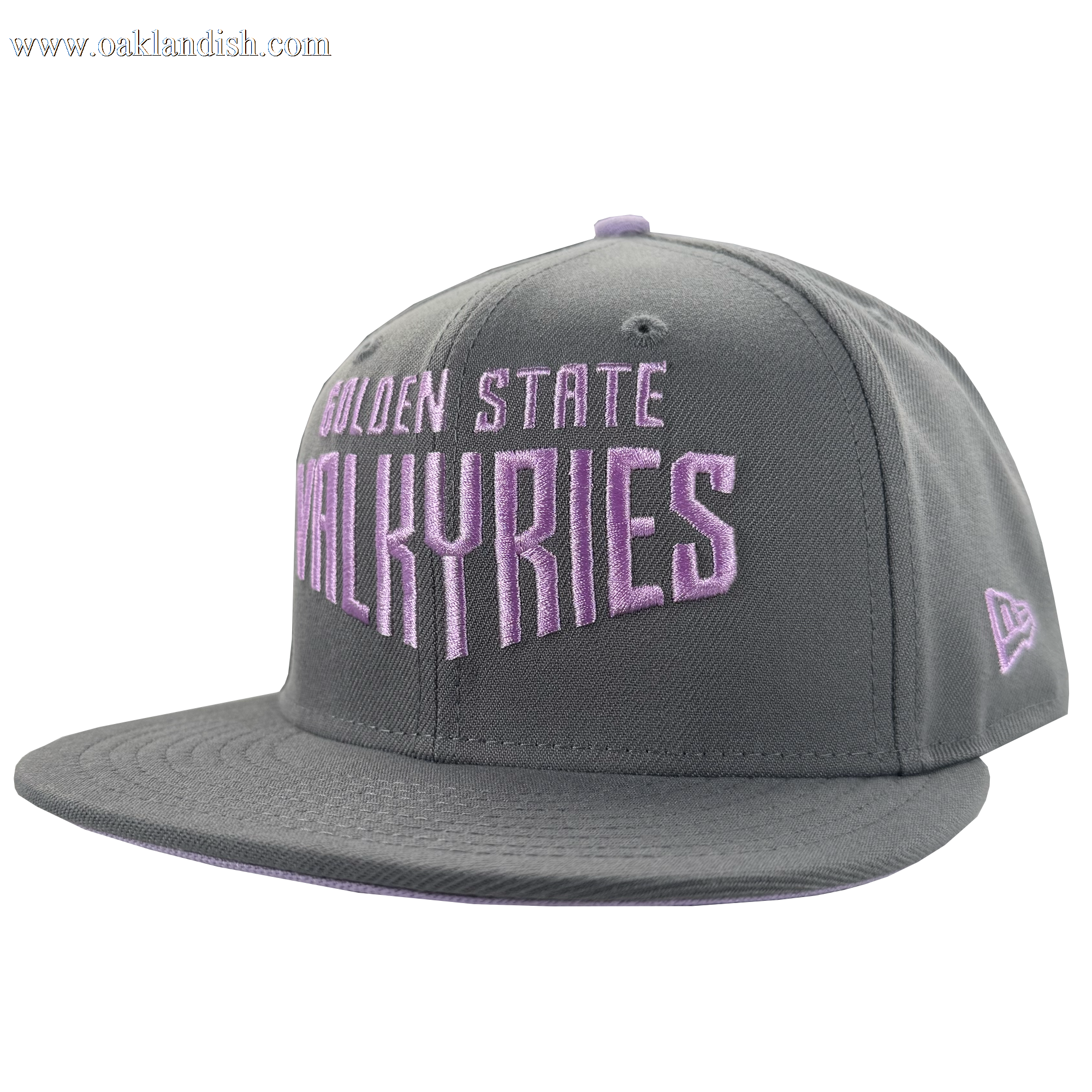 The GSV Wordmark 9FIFTY Snapback by GSV is a gray cap featuring “Golden State Valkyries” in bold light purple embroidery on the front, a purple side logo, adjustable back, top button, and white background.
