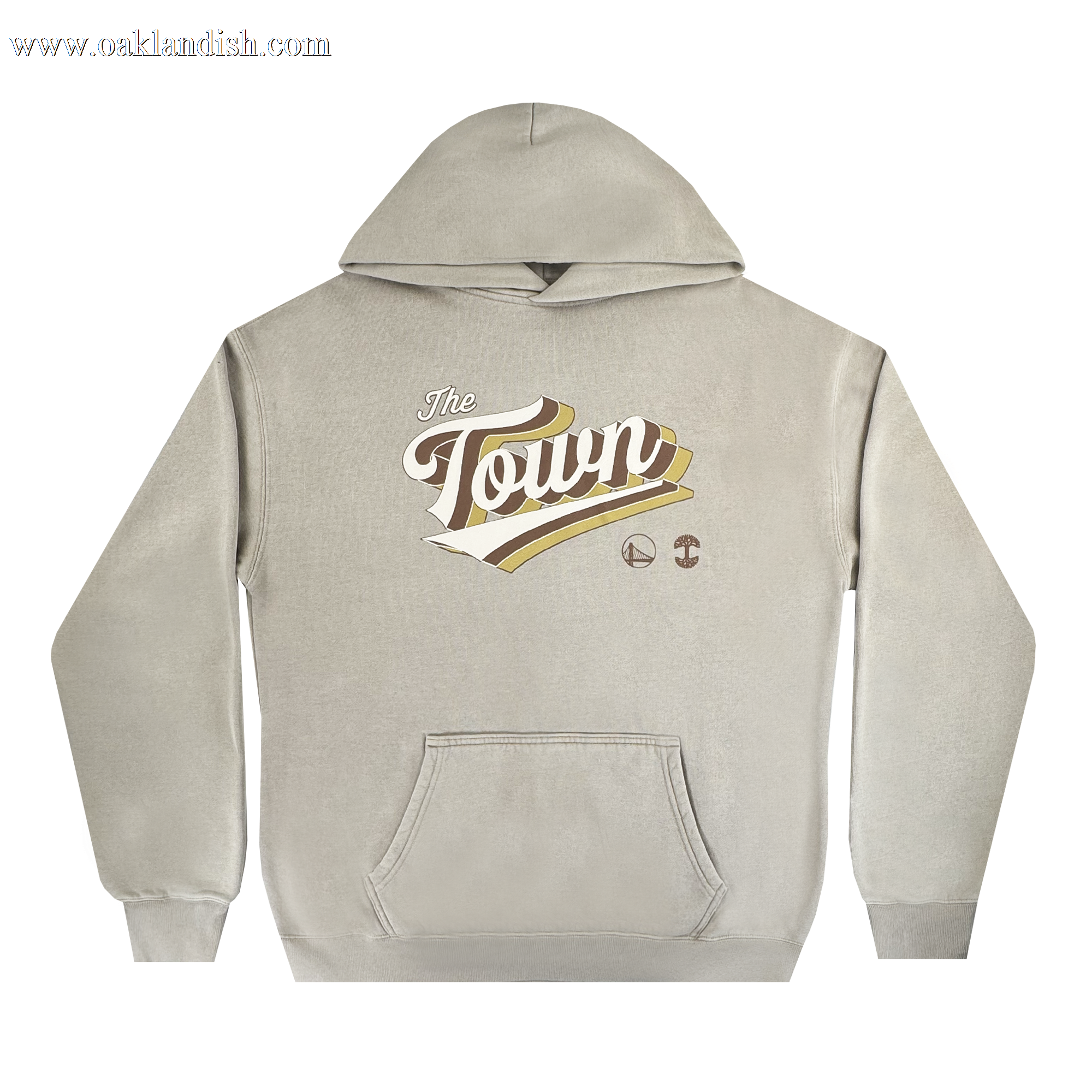 The Vintage Swash Hoodie by Other is a beige pullover featuring a front pocket. Prominently displayed at the center are large, stylized white and gold letters spelling "The Town," inspired by the Warriors x Oaklandish Town Collection, with two small basketball-themed logos beneath. The background is plain white.